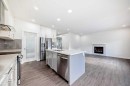 772 Edgefield Crescent, Strathmore, AB  - Indoor Photo Showing Kitchen With Fireplace With Stainless Steel Kitchen With Double Sink With Upgraded Kitchen 