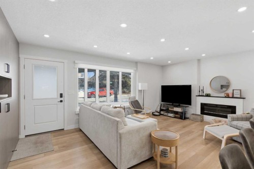 7107 54 Avenue Nw, Calgary, AB - Indoor Photo Showing Living Room With Fireplace