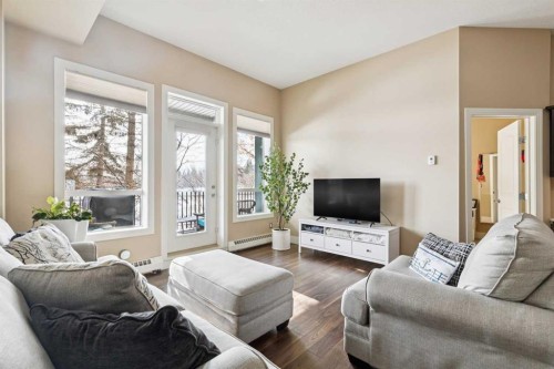 103-3101 34 Avenue Nw, Calgary, AB - Indoor Photo Showing Living Room With Fireplace