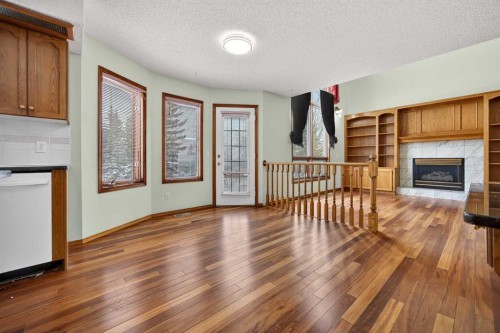 90 Hawkmount Green Nw, Calgary, AB - Indoor Photo Showing Other Room With Fireplace