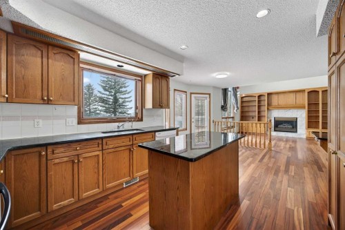 90 Hawkmount Green Nw, Calgary, AB - Indoor Photo Showing Kitchen With Fireplace