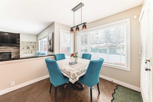 212 Sienna Park Drive Sw, Calgary, AB - Indoor Photo Showing Dining Room With Fireplace