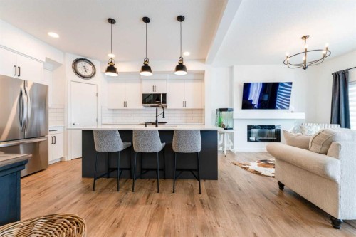 244 Heritage Heights, Cochrane, AB - Indoor Photo Showing Kitchen With Fireplace With Upgraded Kitchen