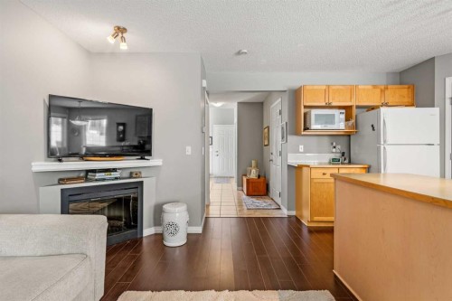 18 Hidden Creek Rise Nw, Calgary, AB - Indoor Photo Showing Kitchen With Fireplace