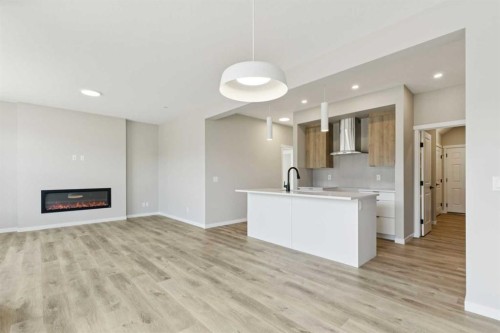302 Hotchkiss Common Se, Calgary, AB - Indoor Photo Showing Other Room With Fireplace