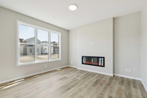 302 Hotchkiss Common Se, Calgary, AB - Indoor Photo Showing Living Room With Fireplace