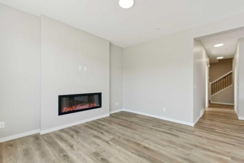 302 Hotchkiss Common Se, Calgary, AB - Indoor Photo Showing Living Room With Fireplace