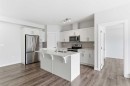 211-25 Walgrove Walk Se, Calgary, AB  - Indoor Photo Showing Kitchen With Stainless Steel Kitchen With Double Sink 