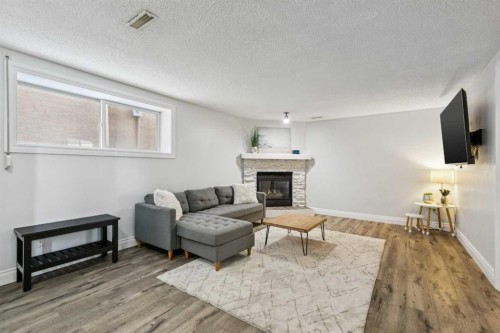 225 Somerset Drive Sw, Calgary, AB - Indoor Photo Showing Living Room With Fireplace