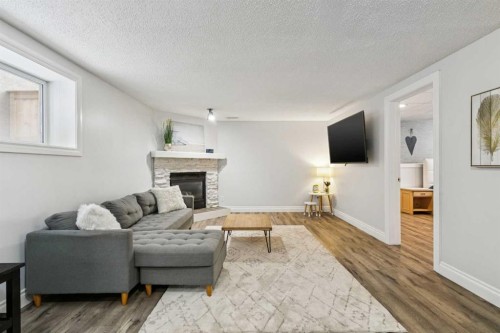 225 Somerset Drive Sw, Calgary, AB - Indoor Photo Showing Living Room With Fireplace