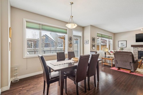 7 Cooperstown Place Sw, Airdrie, AB - Indoor Photo Showing Dining Room With Fireplace