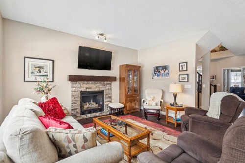 7 Cooperstown Place Sw, Airdrie, AB - Indoor Photo Showing Living Room With Fireplace