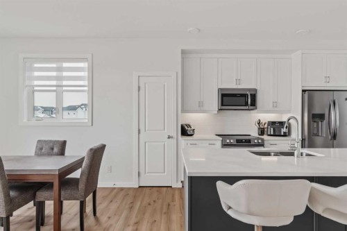 86 Spring Willow Close Sw, Calgary, AB - Indoor Photo Showing Kitchen With Stainless Steel Kitchen With Double Sink With Upgraded Kitchen