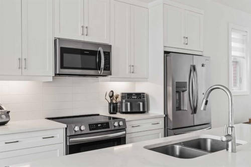 86 Spring Willow Close Sw, Calgary, AB - Indoor Photo Showing Kitchen With Stainless Steel Kitchen With Double Sink With Upgraded Kitchen