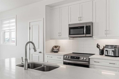 86 Spring Willow Close Sw, Calgary, AB - Indoor Photo Showing Kitchen With Stainless Steel Kitchen With Double Sink With Upgraded Kitchen