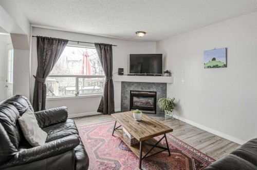 207 Crystalridge Place, Okotoks, AB - Indoor Photo Showing Living Room With Fireplace