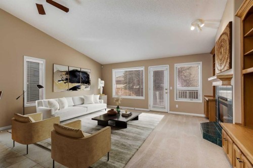 17 Rocky Ridge Villas Nw, Calgary, AB - Indoor Photo Showing Living Room With Fireplace