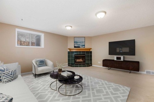 17 Rocky Ridge Villas Nw, Calgary, AB - Indoor Photo Showing Living Room With Fireplace