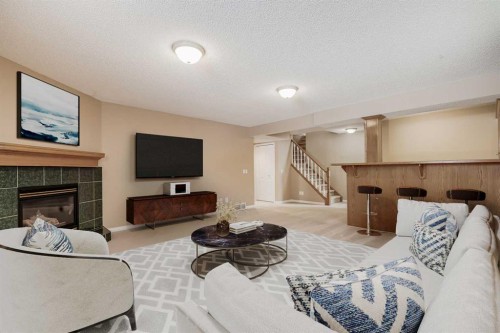 17 Rocky Ridge Villas Nw, Calgary, AB - Indoor Photo Showing Living Room With Fireplace