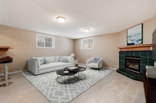 17 Rocky Ridge Villas Nw, Calgary, AB - Indoor Photo Showing Living Room With Fireplace