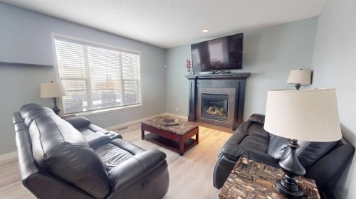 983 Auburn Bay Boulevard Se, Calgary, AB - Indoor Photo Showing Living Room With Fireplace