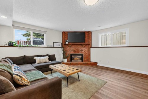 584 Woodhill Place Sw, Calgary, AB - Indoor Photo Showing Living Room With Fireplace