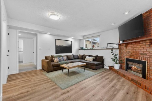 584 Woodhill Place Sw, Calgary, AB - Indoor Photo Showing Living Room With Fireplace