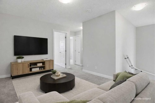 747 Creekside Boulevard Sw, Calgary, AB - Indoor Photo Showing Living Room