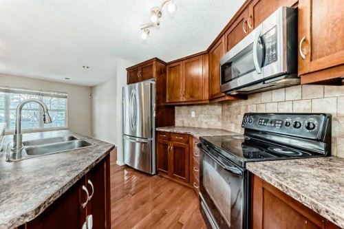 46 Panatella Hill Nw, Calgary, AB - Indoor Photo Showing Kitchen With Double Sink