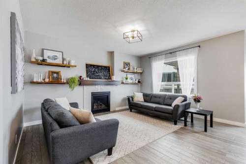 230 Nolanhurst Bay Nw, Calgary, AB - Indoor Photo Showing Living Room With Fireplace