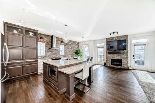 322 Reunion Green Nw, Airdrie, AB - Indoor Photo Showing Other Room With Fireplace