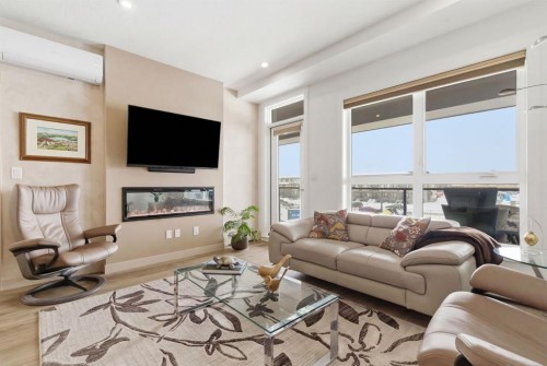 7306-1802 Mahogany Boulevard Se, Calgary, AB - Indoor Photo Showing Living Room With Fireplace