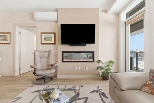 7306-1802 Mahogany Boulevard Se, Calgary, AB - Indoor Photo Showing Living Room With Fireplace