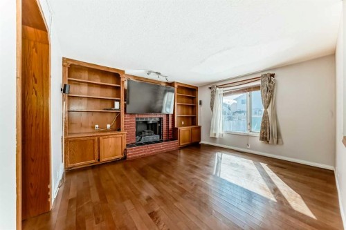 207 Eldorado Close Ne, Calgary, AB - Indoor Photo Showing Other Room With Fireplace