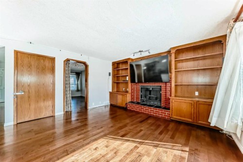 207 Eldorado Close Ne, Calgary, AB - Indoor Photo Showing Living Room With Fireplace