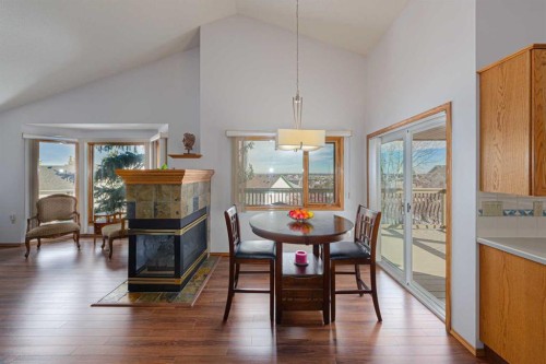20 Somerset Drive Sw, Calgary, AB - Indoor Photo Showing Dining Room With Fireplace