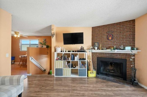 113 Ranch Glen Place Nw, Calgary, AB - Indoor Photo Showing Living Room With Fireplace