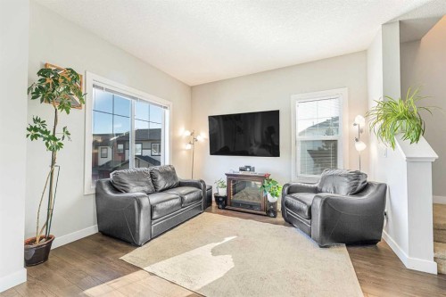 108 Jumping Pound Common, Cochrane, AB - Indoor Photo Showing Living Room With Fireplace