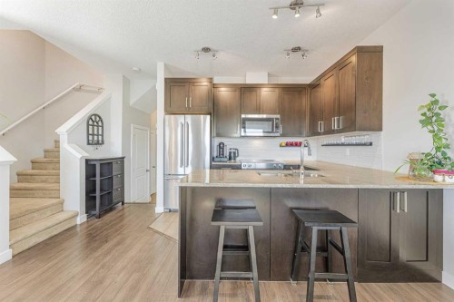 108 Jumping Pound Common, Cochrane, AB - Indoor Photo Showing Kitchen With Upgraded Kitchen
