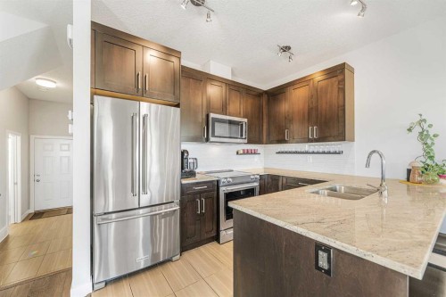 108 Jumping Pound Common, Cochrane, AB - Indoor Photo Showing Kitchen With Double Sink With Upgraded Kitchen