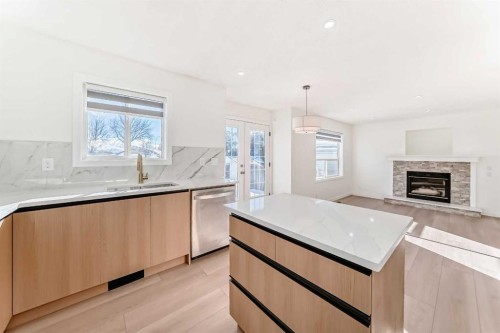 6 Arbour Stone Rise Nw, Calgary, AB - Indoor Photo Showing Kitchen With Fireplace