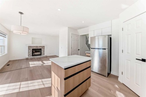 6 Arbour Stone Rise Nw, Calgary, AB - Indoor Photo Showing Kitchen With Fireplace