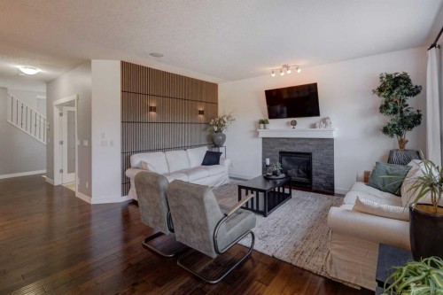 213 Kingsmere Cove Se, Airdrie, AB - Indoor Photo Showing Living Room With Fireplace