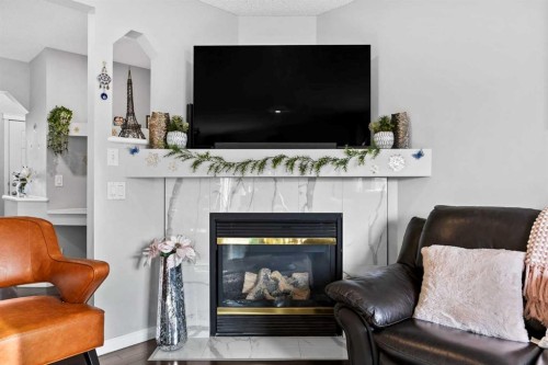 465 Panamount Boulevard Nw, Calgary, AB - Indoor Photo Showing Living Room With Fireplace