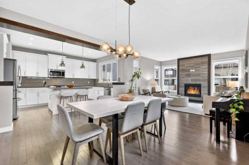 9 Legacy Lane Se, Calgary, AB - Indoor Photo Showing Dining Room With Fireplace