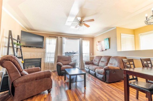 302-605 19 Street Se, High River, AB - Indoor Photo Showing Living Room With Fireplace