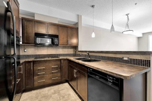 318-26 Val Gardena View Sw, Calgary, AB - Indoor Photo Showing Kitchen With Double Sink