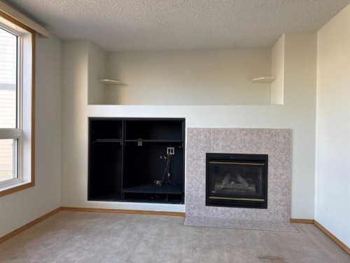 244 Los Alamos Place Ne, Calgary, AB - Indoor Photo Showing Living Room With Fireplace