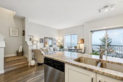 1502 Jumping Pound Common, Cochrane, AB - Indoor Photo Showing Kitchen With Double Sink