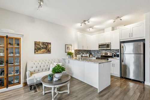 1502 Jumping Pound Common, Cochrane, AB - Indoor Photo Showing Kitchen With Stainless Steel Kitchen With Upgraded Kitchen